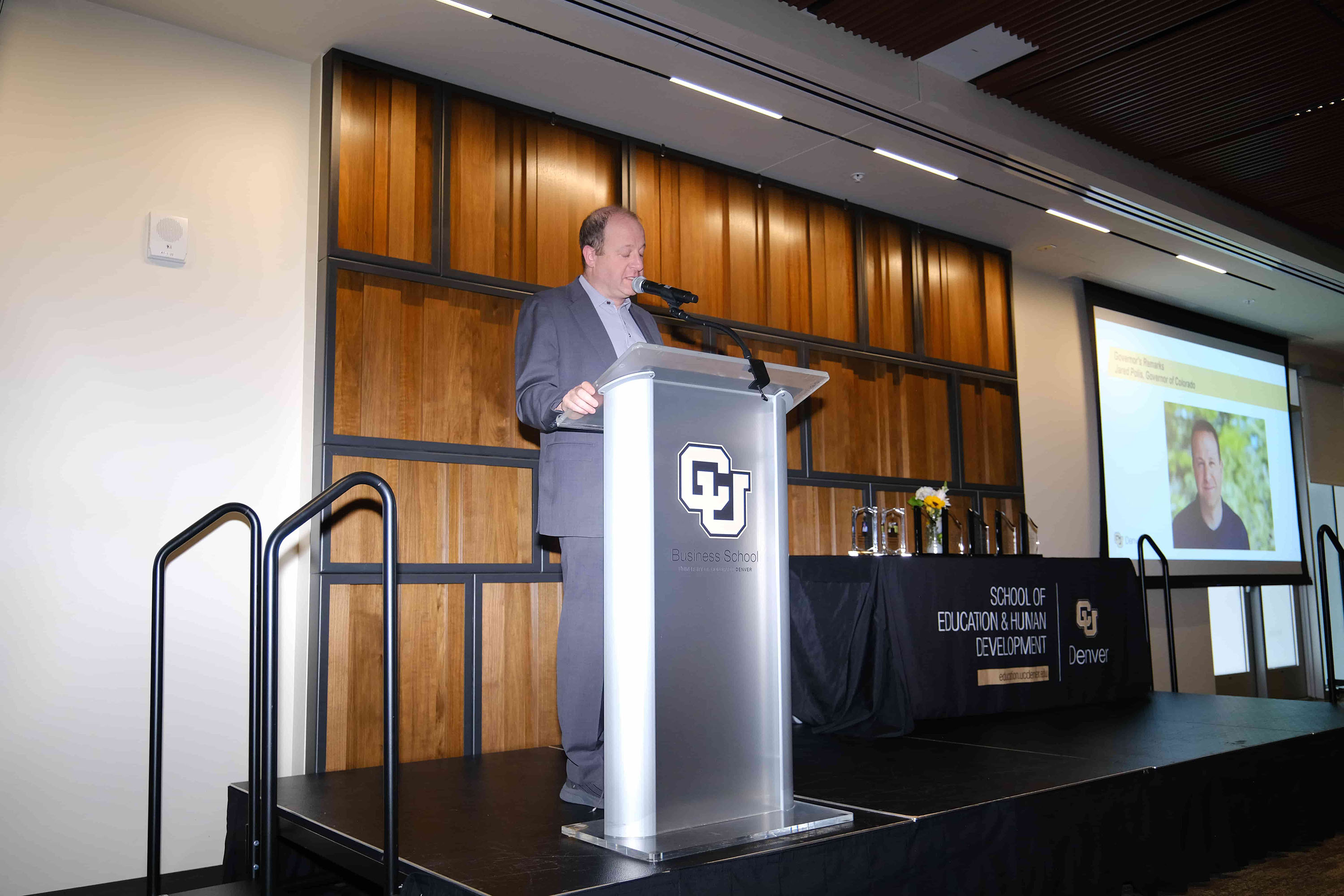 Governor Jared Polis speaking at the event