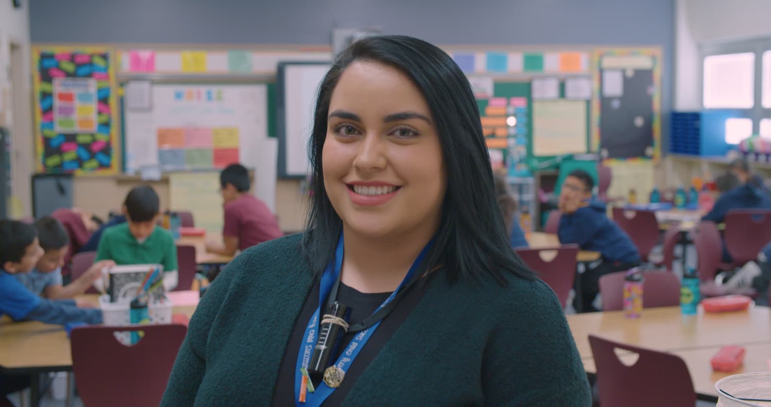 MAT-short-term-funding Teacher in front of classroom